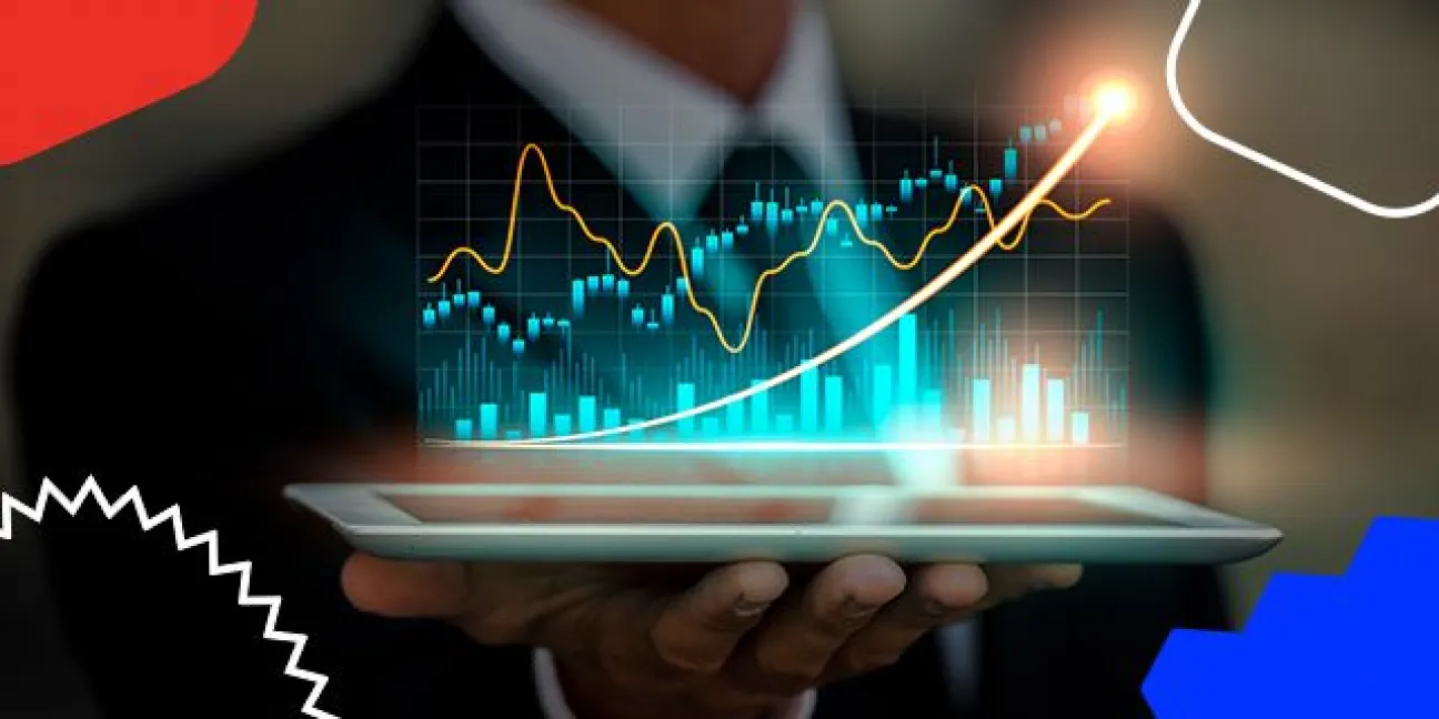 Person in a suit holding a tablet showing glowing stock charts and upward-trending lines for financial analytics.